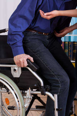 Disabled gets up of the truck with the help of a nurse
