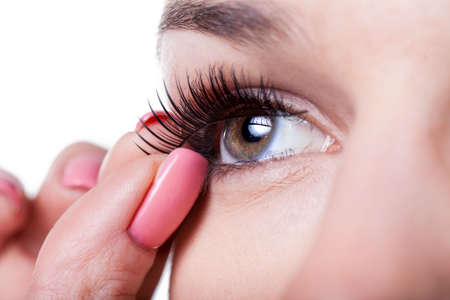 Close-up of a woman applying false eyelashesの写真素材