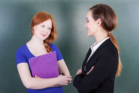 Smart female student and her teacher, horizontal