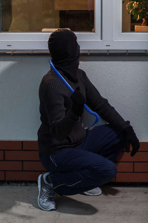 Burglar trying to break into the houseの写真素材