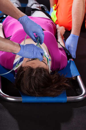 Unconscious victim of accident lying on stretcher