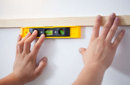 Man's hands with the level during renovation