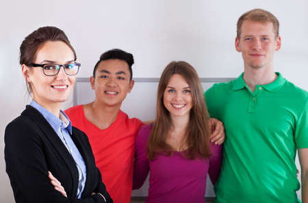 Portrait of a teacher with her multi-ethnic students