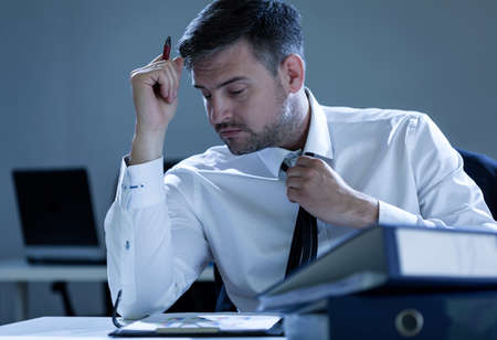 Businessman working overtime in the office, horizontalの写真素材