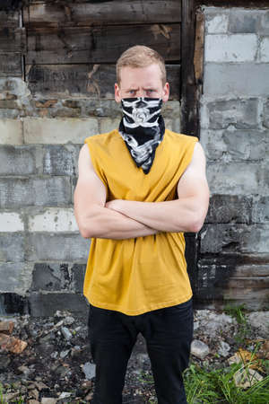 Portrait of angry young rebel with bandana on faceの写真素材