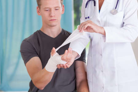 Closeup of young man with bandaged handの写真素材