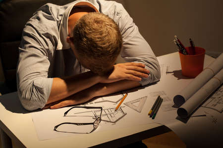 View of sleepy architect resting at nightの写真素材
