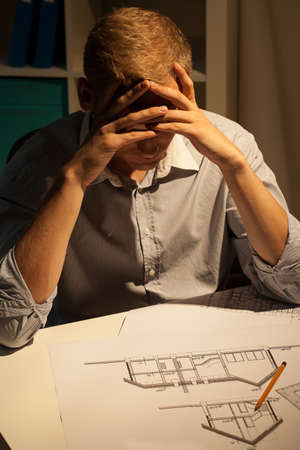 Architect making a project at night, verticalの写真素材
