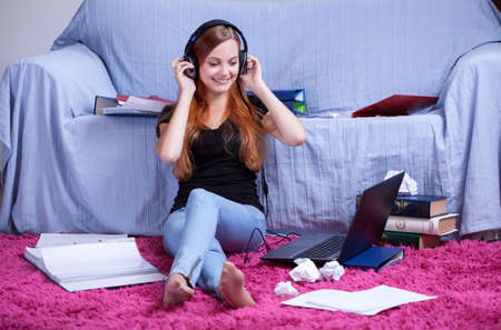 Girl listening to music instead of learning