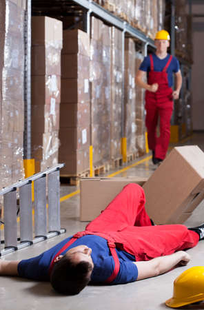 Vertical view of a warehouseman after accident at heightの写真素材