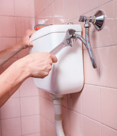 Close-up of a professional toilet reparation, verticalの写真素材