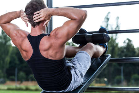 Man training on the outdoor gym, horizontal