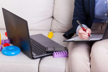 Working mother among child's toys at home