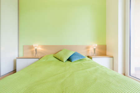 Interior of bedroom with green wall, horizontalの写真素材