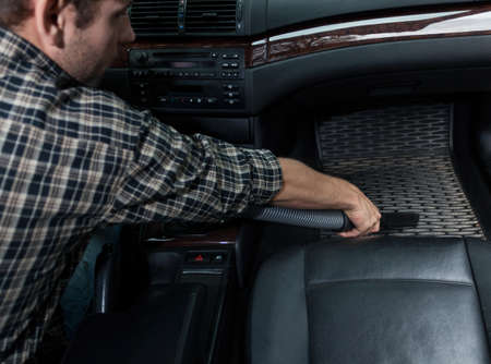 View of dusting car with vacuum cleanerの写真素材