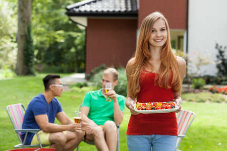 Young woman during garden party with friendsの写真素材