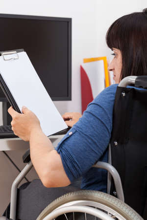 Vertical view of a working disabled girl 