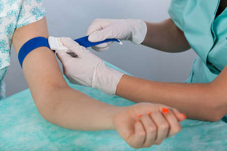 Patient before taking blood sample at doctor's officeの写真素材