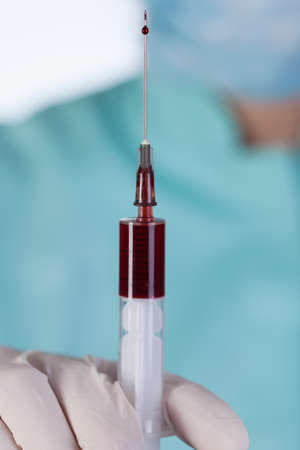 Vertical close-up of syringe with a bloodの写真素材