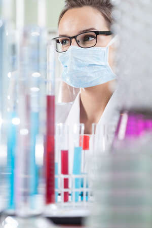 Vertical view of scientist with test tubes