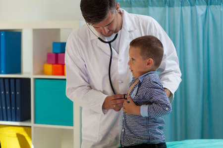 Examining little boy at pediatrician's office, horizontalの写真素材