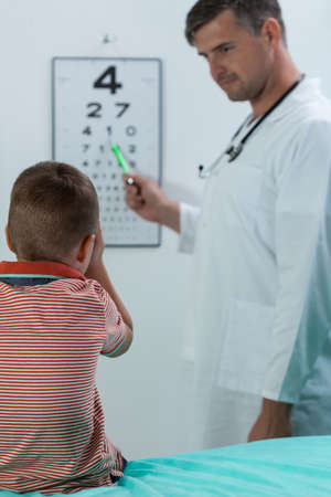 Vertical view of boy during vision examinationの写真素材