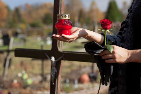 Woman is putting the snitch on the grave of close personの写真素材