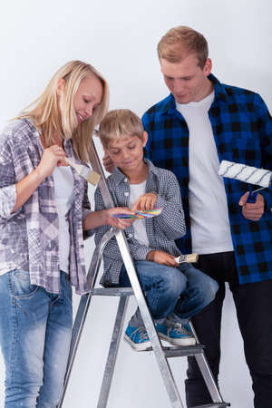 Child choosing a color to paint a room, verticalの写真素材