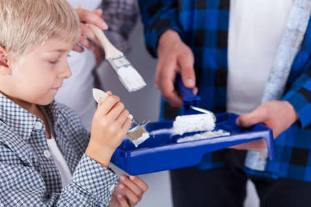 Close-up of a little boy with paintbrushの写真素材