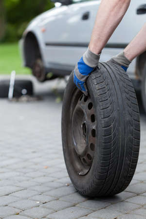 Vertical view of rolling a spare of wheel