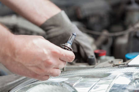 Changing a bulb in a car, horizontal