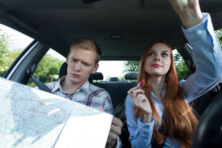 View of woman making up in car