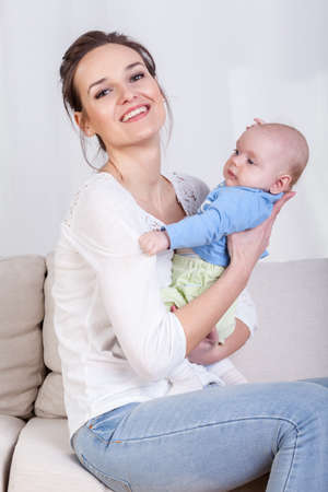 Young mum caring baby in her arms