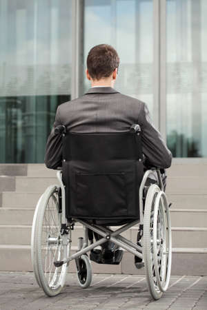 Disabled office worker is unable to get to the buildingの写真素材