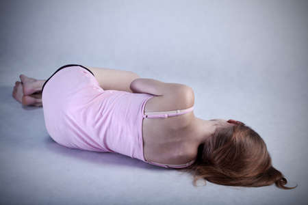 Depressed young woman lying o the floorの写真素材