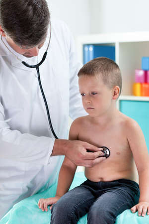 Doctor examining little boy in cabinetの写真素材