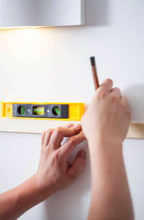 Close-up of handyman's hands with spirit level