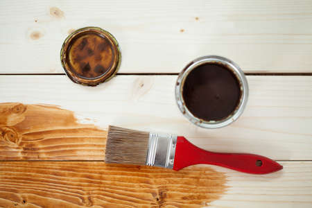 Paint can and paintbrush on wooden planks, horizontalの写真素材