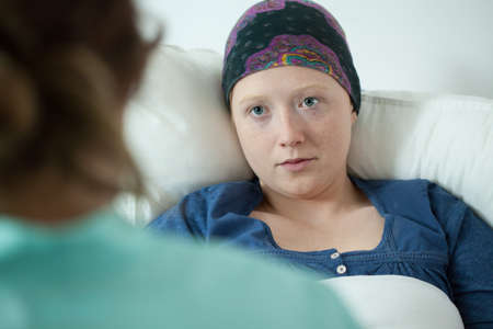 Close-up of ill with leukemia girl wearing headscarf