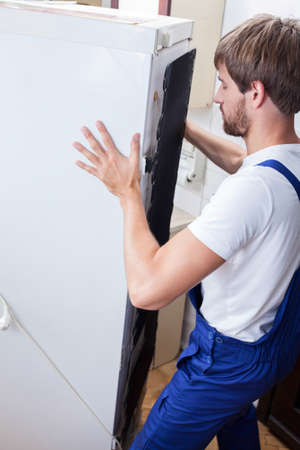 Vertical view of fixing fridge at homeの写真素材