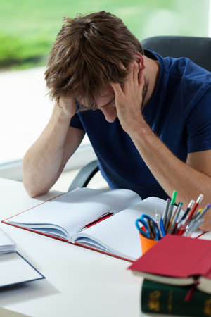 Young student depressed and tired before hard examination