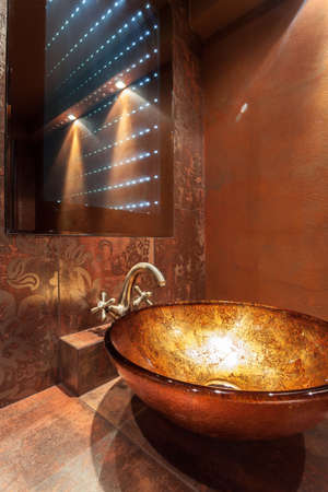 Glass washbowl and modern mirror in luxury bathroomの写真素材