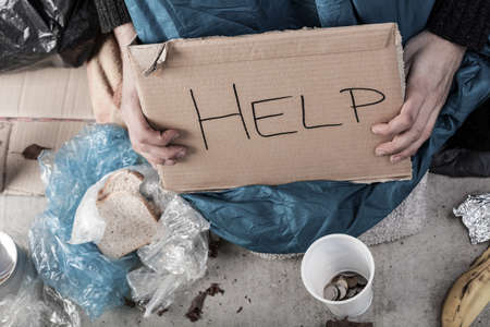 A homeless man on the street asking for money