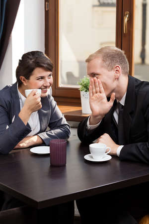 Friends from work drinking coffee in coffeehouseの写真素材