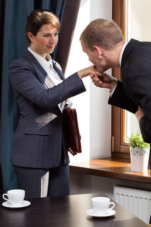 Elegant businessman kissing woman in the handの写真素材