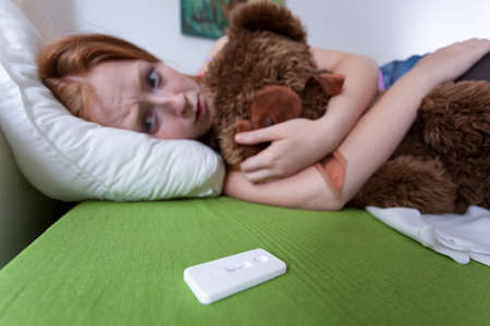 Sad scared teen realized that she is expecting a babyの写真素材