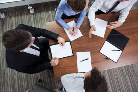 Coworkers meet to discuss their last projectの写真素材