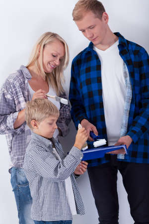 View of young family painting new roomの写真素材