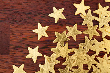 Golden christmas stars on a tableの写真素材