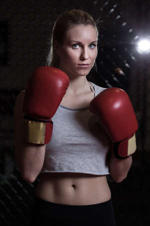 Young pretty woman with boxing gloves ready to boxの写真素材